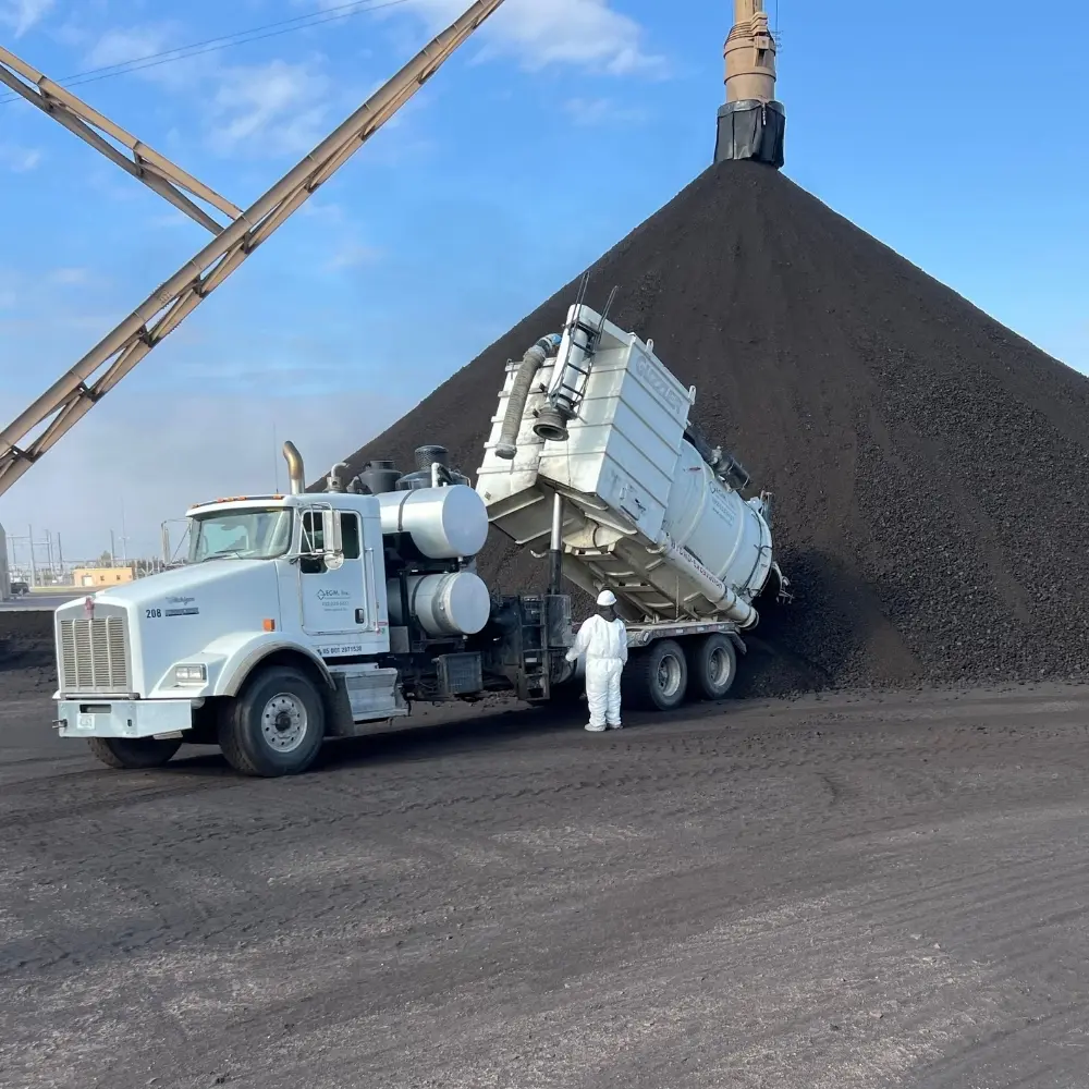 EGM vacuum truck recovering dry industrial material at a facility
